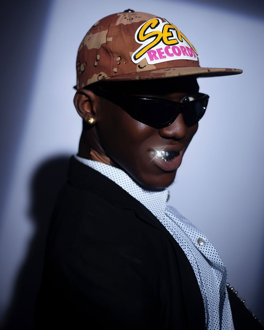Close portrait of Tabby Blakes wearing a cap and sunglasses
